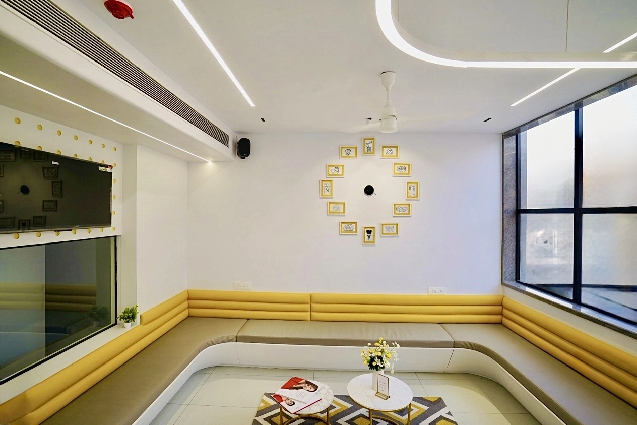 Bright yellow and white waiting lounge at Bhai-Bhai Dental Clinic